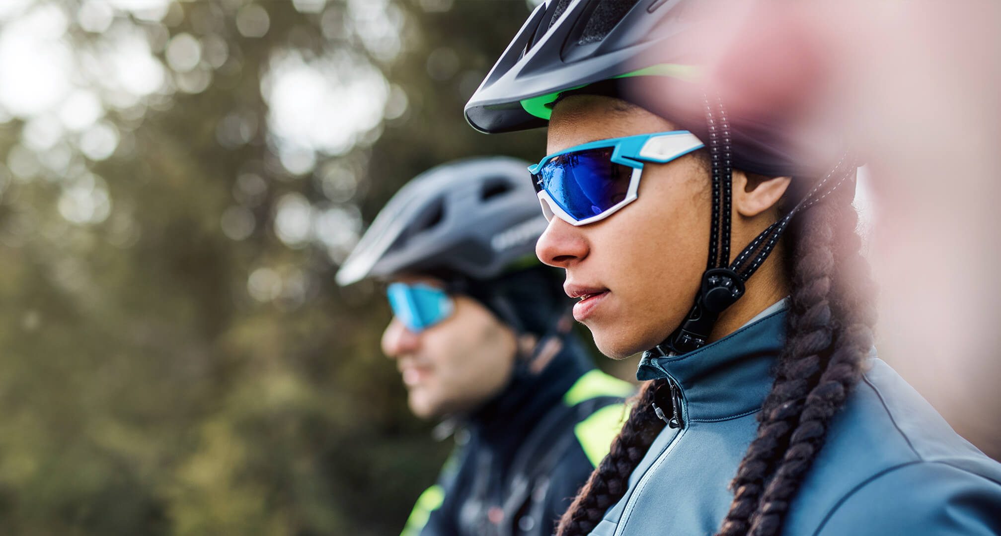 due persone che indossano occhiali da sole e caschi da ciclismo